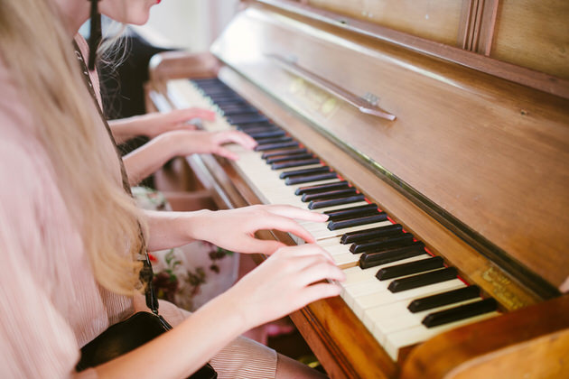 Girls playing the piano
